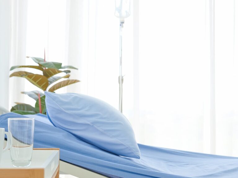 clean-clear-empty-hospital-near-sunny-window-blue-bed-linen-with-white-curtain-ward-room-background (2) (1)